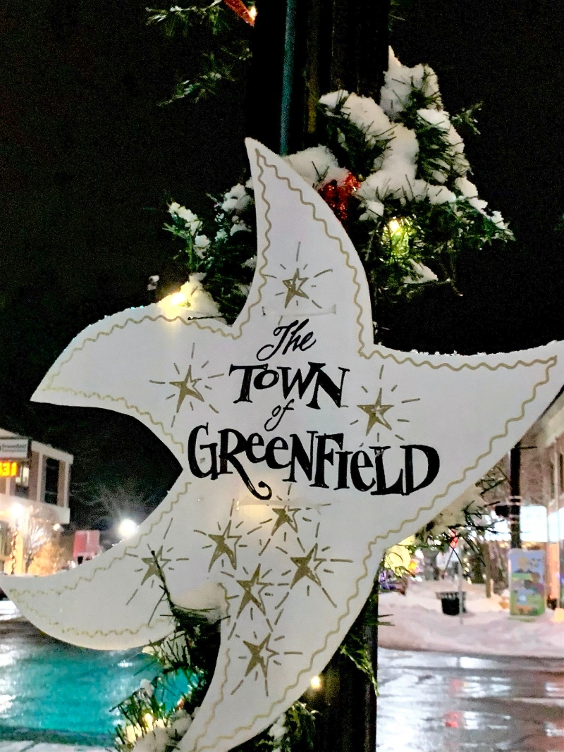 greenfield business association star on a lit garland pole