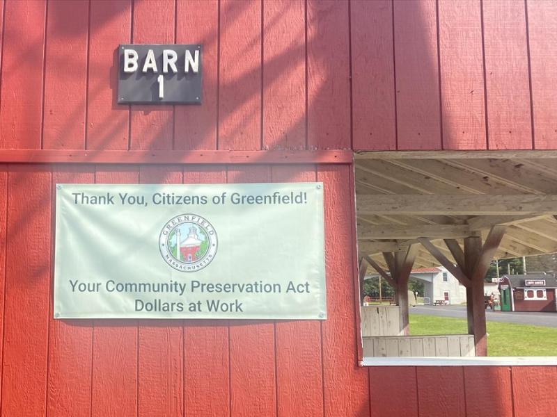 photo of side of a red barn with signage